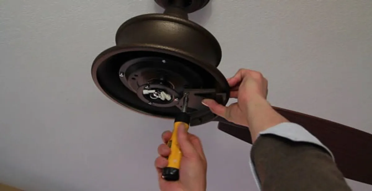 Electrician installing ceiling fan mounting bracket and fixture in Salt Lake City, UT