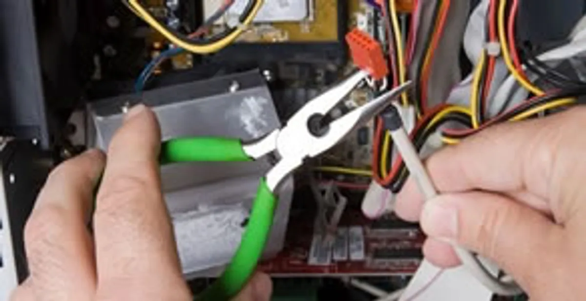 Licensed electrical contractor performing electrical repair with tools in Midvale, UT