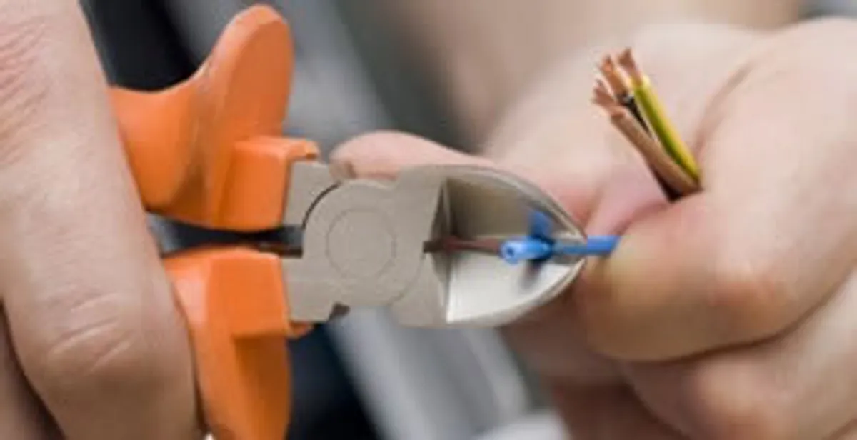 licensed electrician performing precise wire cutting and preparation during electrical service in Salt Lake City, UT